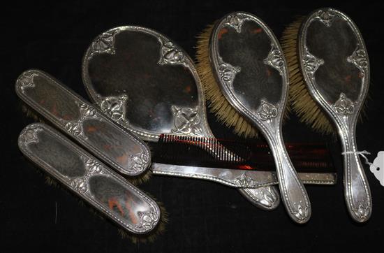 An Edwardian and later silver and tortoiseshell mounted six piece dressing table set,